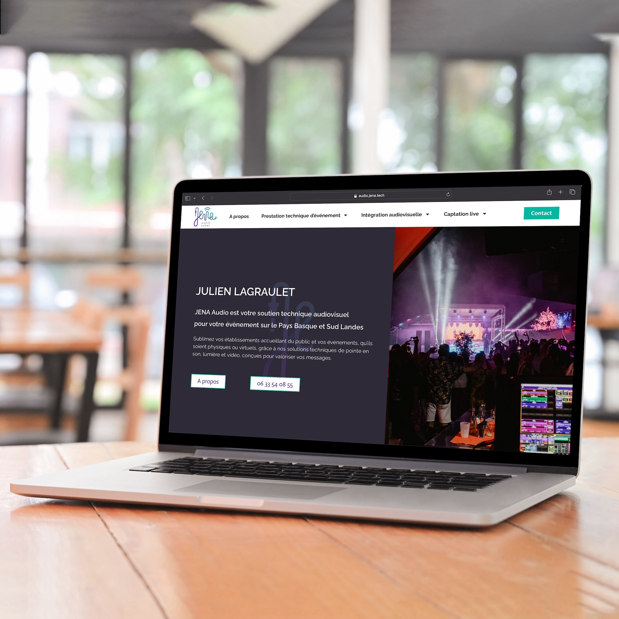 Laptop computer on wooden table with empty screen.